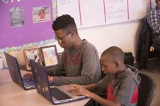 Two students doing work on the computer.