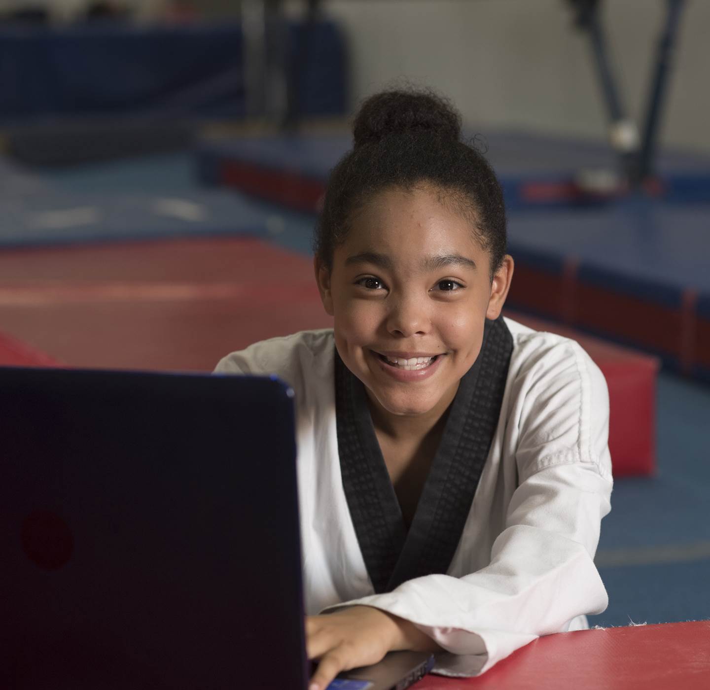 A student on the computer at a karate class.
