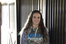 A woman posing in the stables.