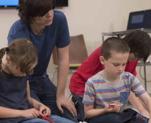 Four children playing with legos.