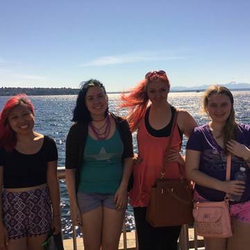 Courtney Thurston posing on a dock with three other women.