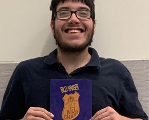 Billy Kraser holding a book.