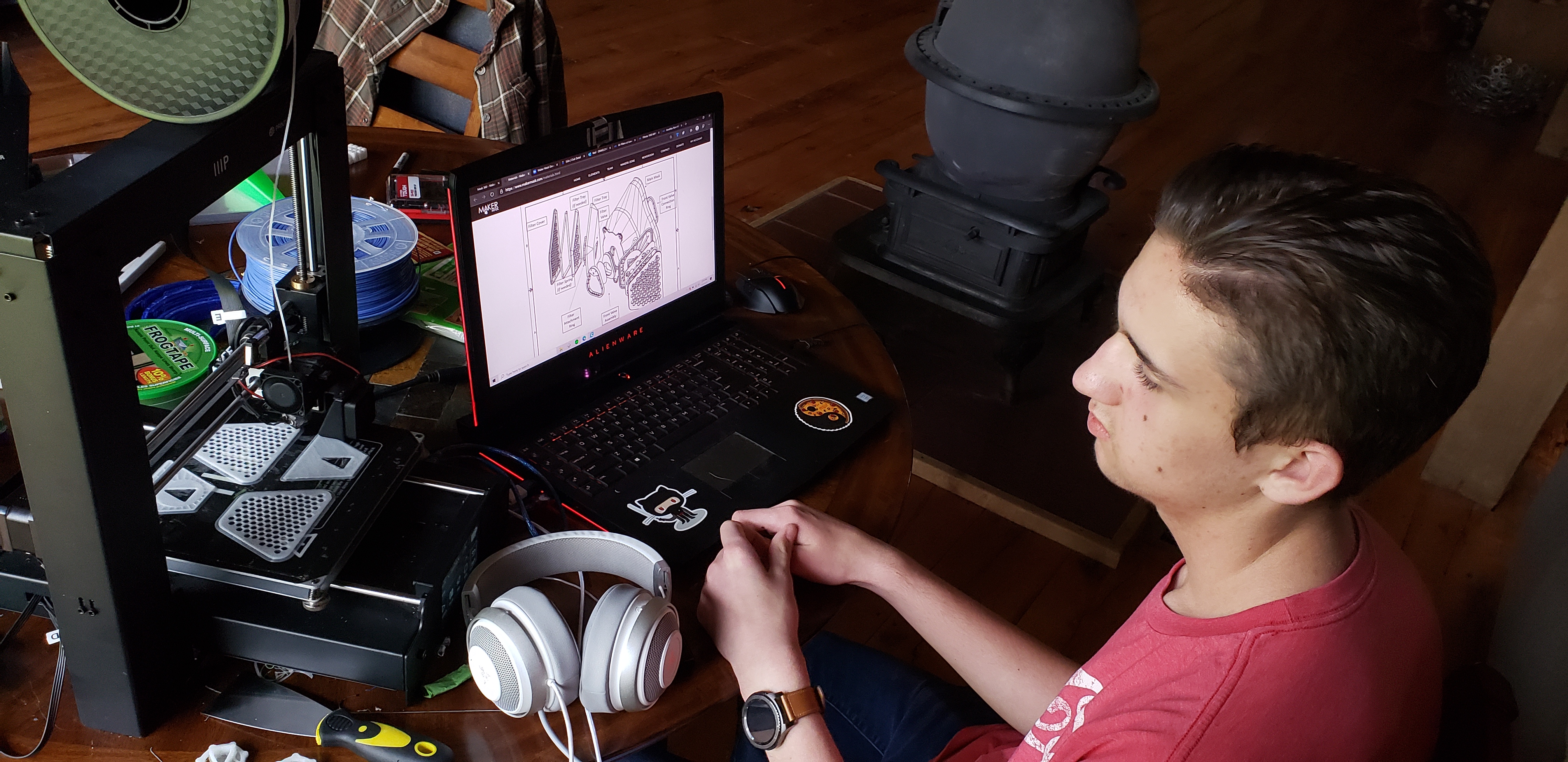 Drake Christianson works on creating face masks for a local hospital using his 3D printer.