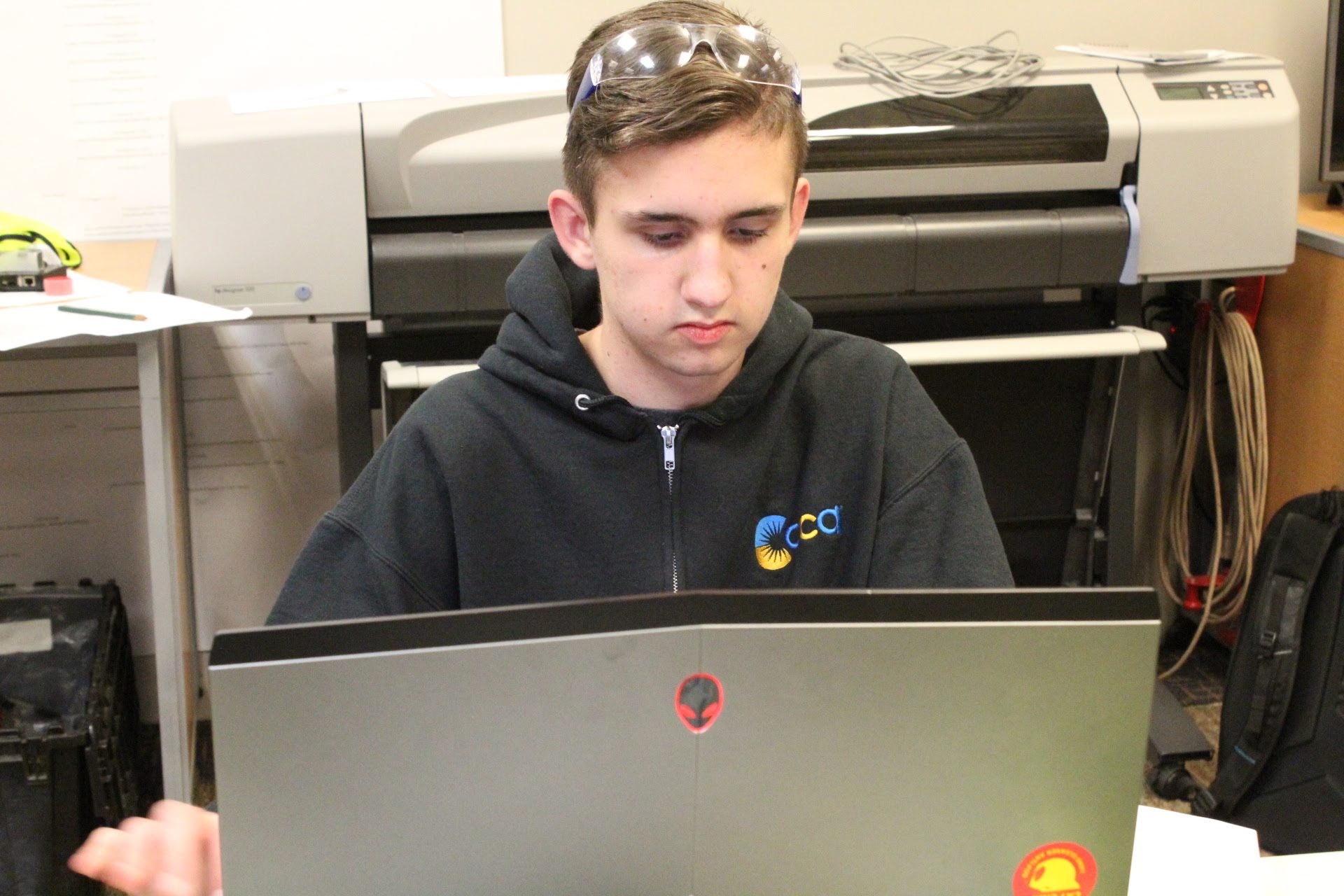 Drake Christianson works on creating face masks for a local hospital using his 3D printer.