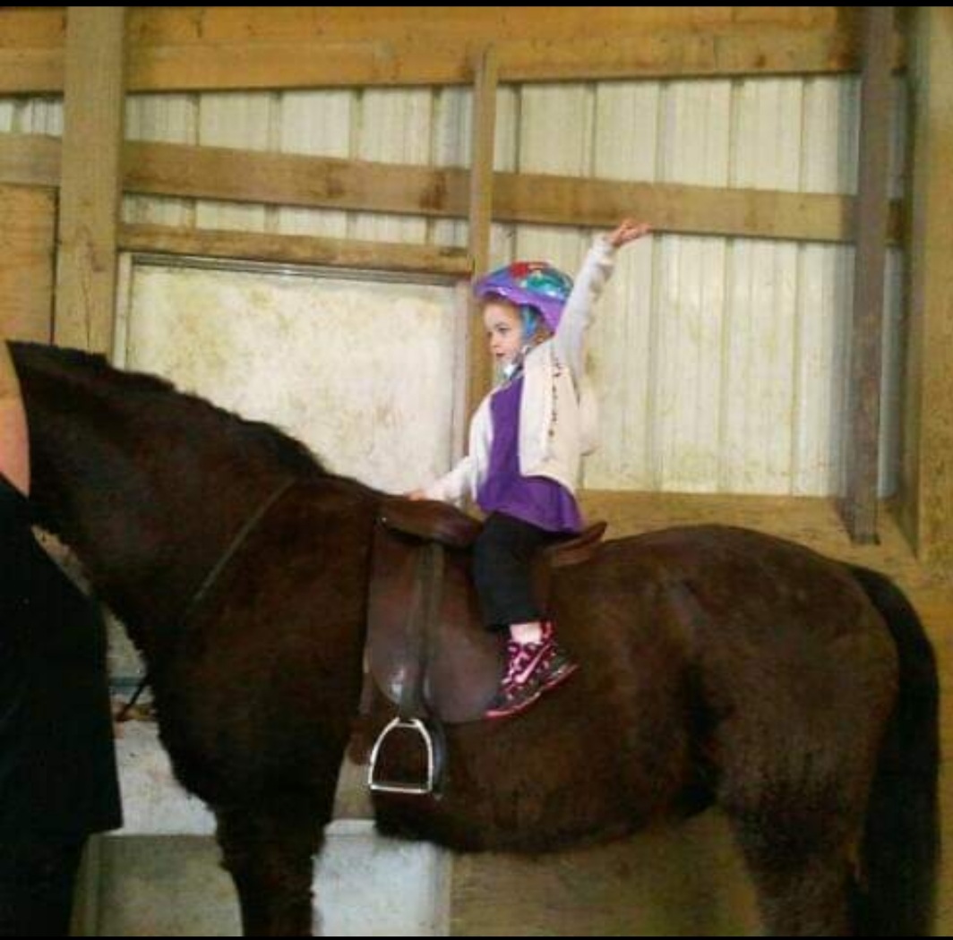 Bella riding her first horse