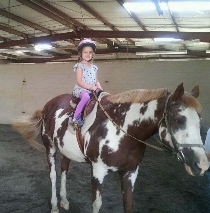 Bella riding a horse at her grandma's house