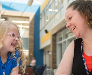 a woman and a child laughing together