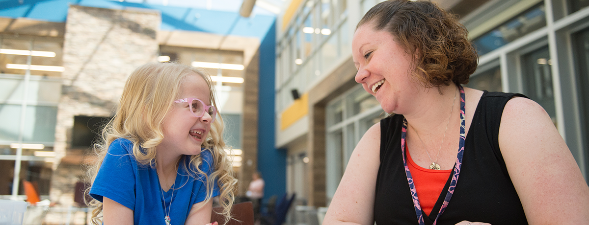 a woman and a child laughing together