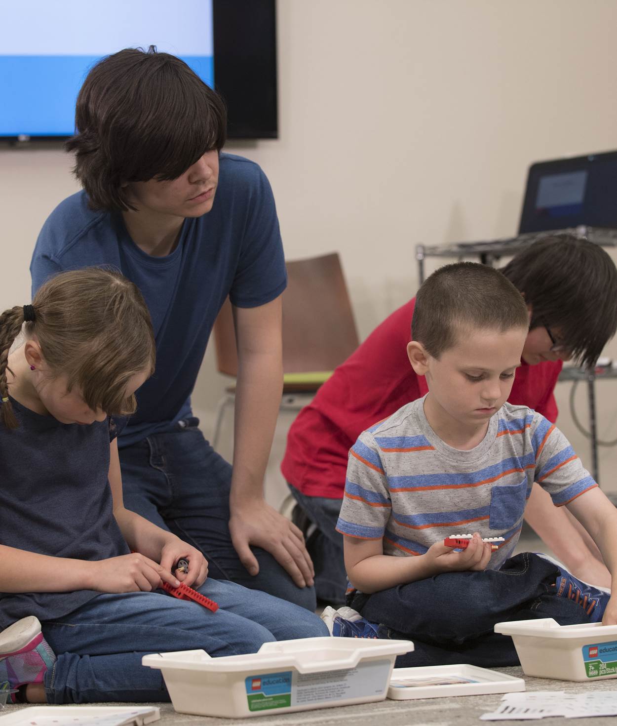 Four children playing with legos.